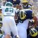 Michigan sophomore running back Fitzgerald Toussaint jumps over the pile to score a touchdown during the third quarter against Eastern Michigan at Michigan Stadium on Saturday. Melanie Maxwell I AnnArbor.com